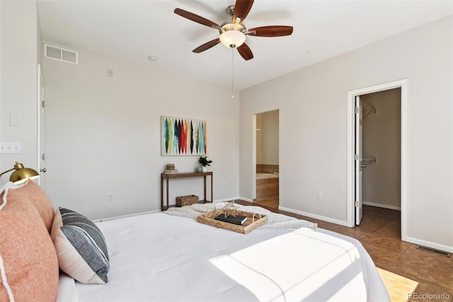 14247 W 84th Cir Unit A, Arvada, CO 80005 - tiled bedroom featuring a walk in closet, connected bathroom, and ceiling fan