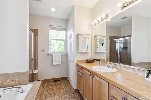 14247 W 84th Cir Unit A, Arvada, CO 80005 - full bath with a shower stall, vanity, and a garden tub