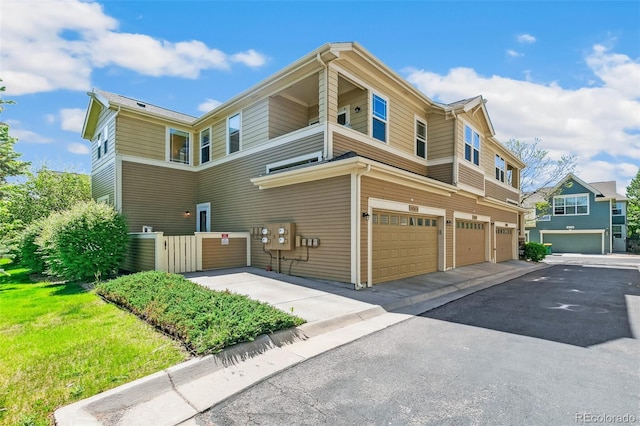 14247 W 84th Cir Unit A, Arvada, CO 80005 - view of home's exterior featuring a garage and driveway