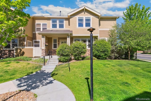 14247 W 84th Cir Unit A, Arvada, CO 80005 - view of front of property featuring a front lawn and stone siding