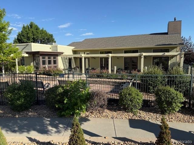 14247 W 84th Cir Unit A, Arvada, CO 80005 - view of front facade with a chimney