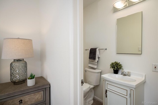 half bath featuring toilet and vanity