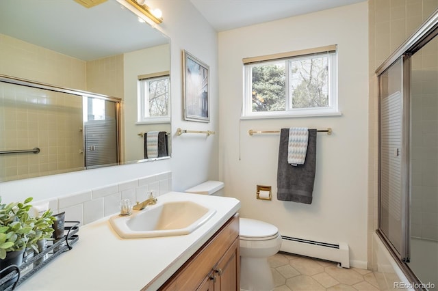 bathroom with vanity, tile patterned flooring, a baseboard heating unit, toilet, and tasteful backsplash