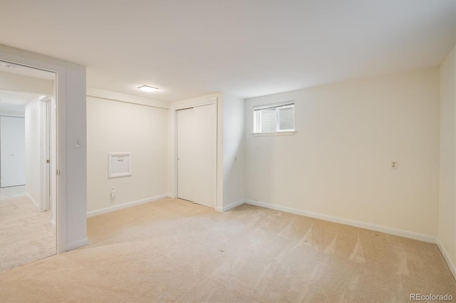 basement with light colored carpet and baseboards