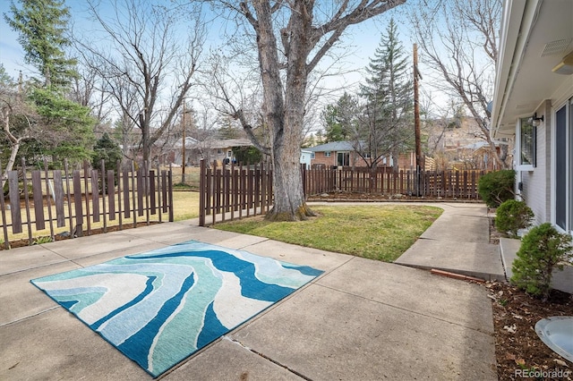 exterior space featuring a fenced front yard and a patio area