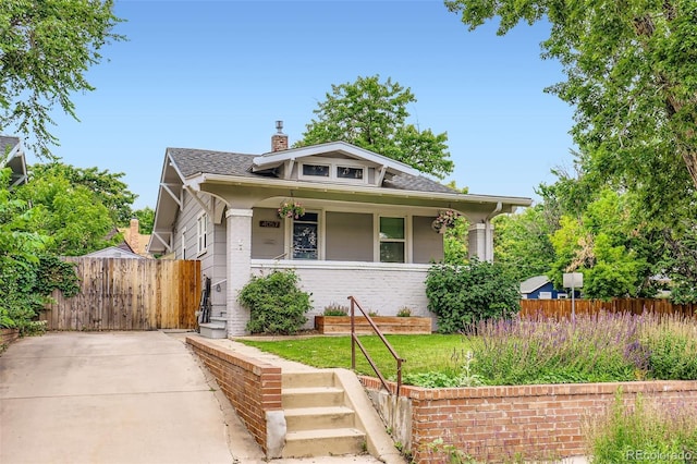 4057 Bryant St, Denver, CO 80211 - bungalow with a porch, a chimney, roof with shingles, and brick siding