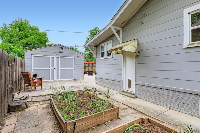 4057 Bryant St, Denver, CO 80211 - view of patio / terrace with a vegetable garden and a storage unit