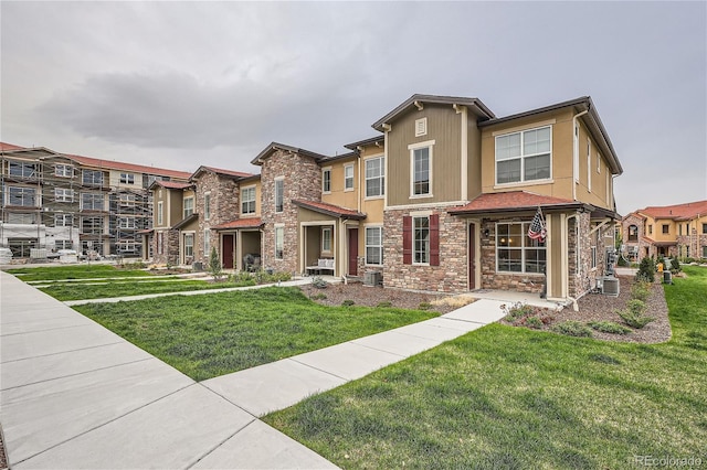 view of front facade featuring stone siding and a front lawn