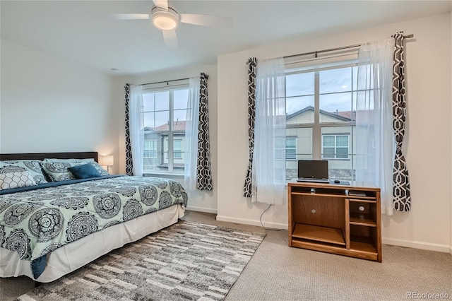 carpeted bedroom featuring baseboards and ceiling fan