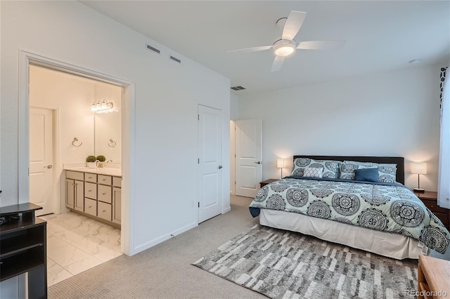 bedroom with connected bathroom, light marble finish flooring, and ceiling fan