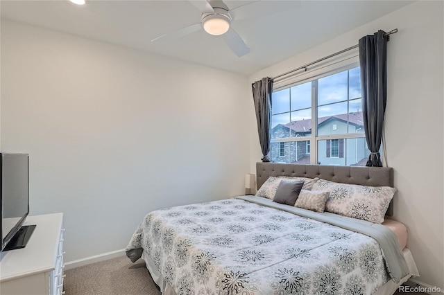 bedroom with carpet flooring, baseboards, and a ceiling fan