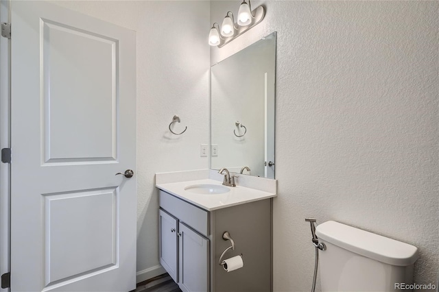 half bath with vanity and toilet