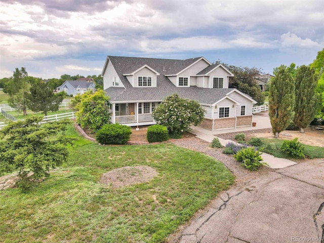 10170 E 151st Ct, Brighton, CO 80602 - view of front facade featuring brick siding, a shingled roof, and covered porch