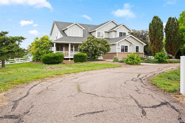 10170 E 151st Ct, Brighton, CO 80602 - traditional home with brick siding, a porch, and roof with shingles