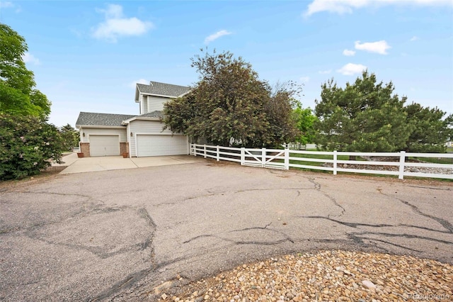10170 E 151st Ct, Brighton, CO 80602 - view of front of house with a fenced front yard, brick siding, concrete driveway, a garage, and roof with shingles
