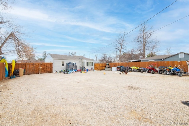 view of yard featuring a fenced backyard and a gate