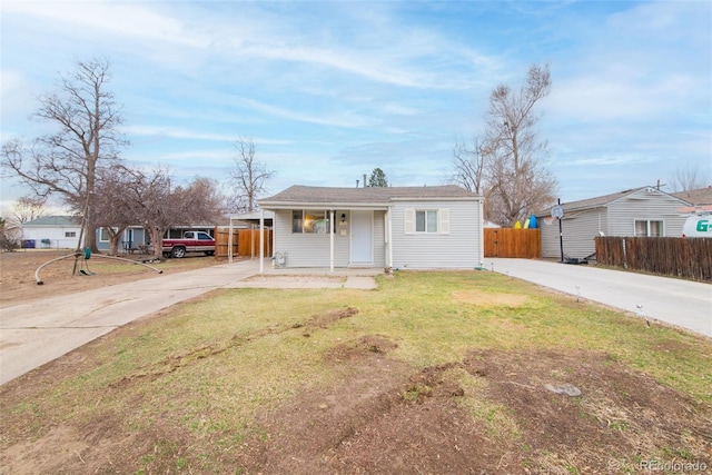 view of front of home with driveway, a front lawn, and fence