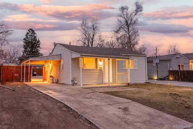 view of front of home with fence, a porch, and roof with shingles