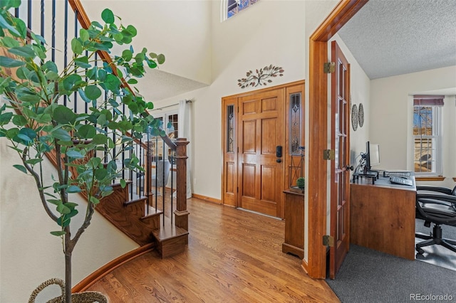 entrance foyer with light wood-type flooring and a textured ceiling