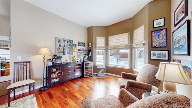 sitting room with baseboards and wood finished floors