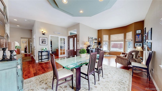 dining space featuring recessed lighting, baseboards, wood finished floors, and french doors