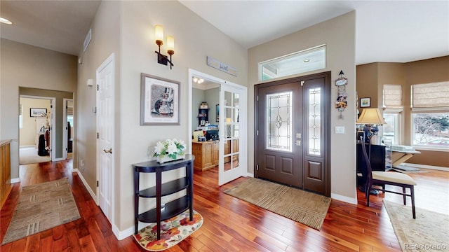 foyer featuring hardwood / wood-style flooring and baseboards