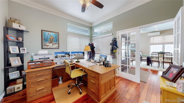 home office with light wood-style floors, french doors, a wall mounted air conditioner, and a ceiling fan