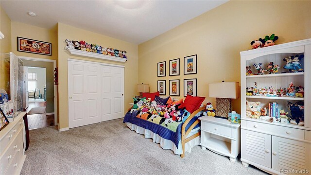 bedroom with a closet and light colored carpet