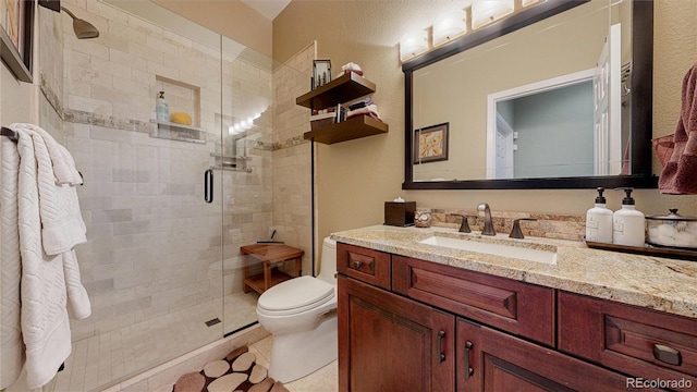 full bathroom featuring a stall shower, vanity, toilet, and tile patterned floors