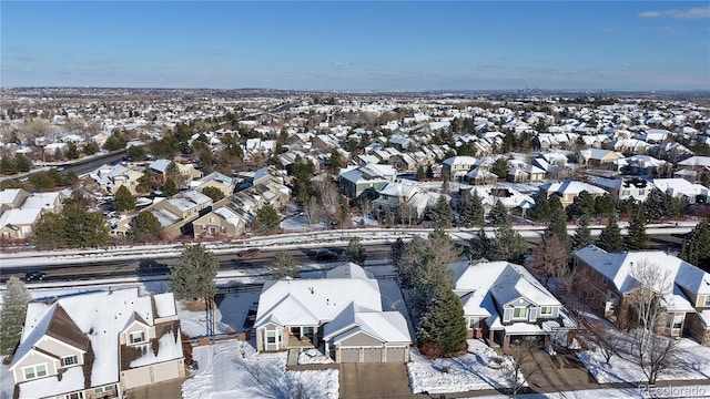 snowy aerial view featuring a residential view