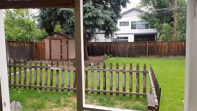 view of yard with a fenced backyard, a storage shed, and an outdoor structure