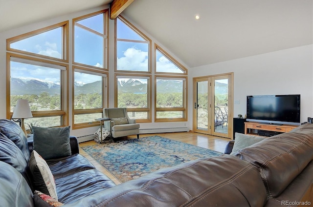 living room with high vaulted ceiling, light wood-type flooring, a baseboard radiator, a mountain view, and beam ceiling