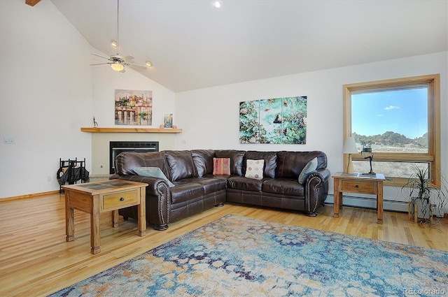 living room featuring lofted ceiling, a baseboard heating unit, and hardwood / wood-style floors