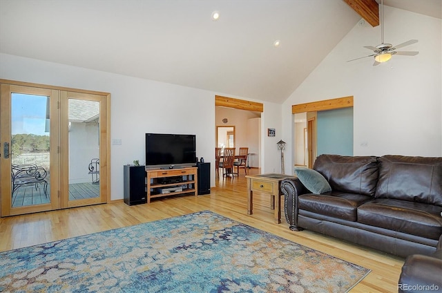 living room featuring lofted ceiling with beams, hardwood / wood-style floors, and ceiling fan