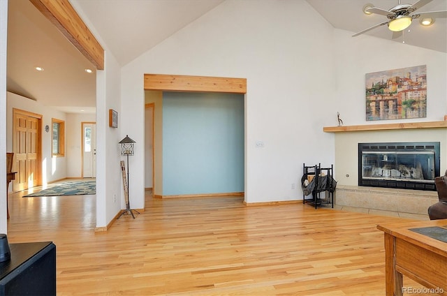 living room featuring ceiling fan, high vaulted ceiling, and light hardwood / wood-style floors