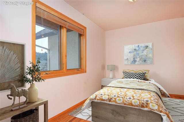 bedroom with wood-type flooring