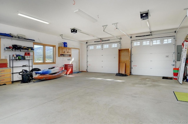 garage featuring a garage door opener and electric panel