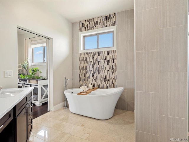 14025 Florence Ct, Brighton, CO 80602 - bathroom featuring a freestanding tub, vanity, and tile walls