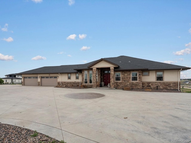 14025 Florence Ct, Brighton, CO 80602 - prairie-style house with stone siding, curved driveway, an attached garage, and stucco siding