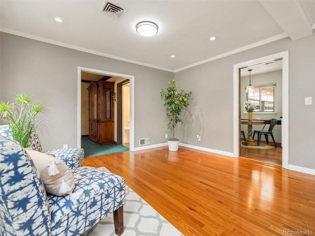 sitting room featuring hardwood / wood-style floors and ornamental molding