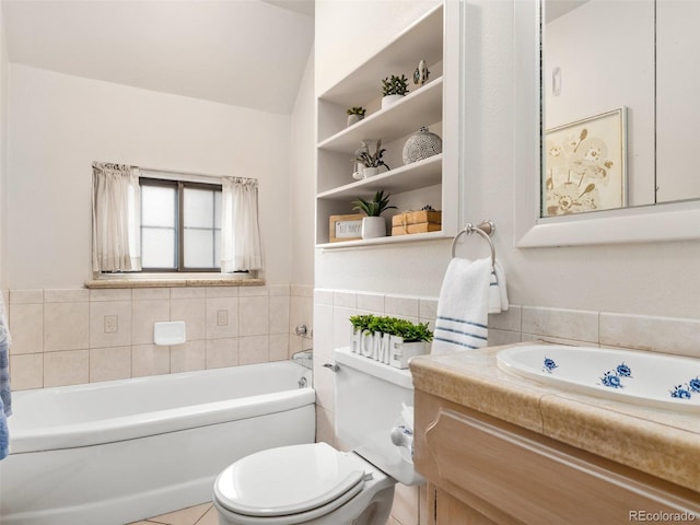 bathroom with toilet, tile patterned flooring, a bathtub, vanity, and tile walls