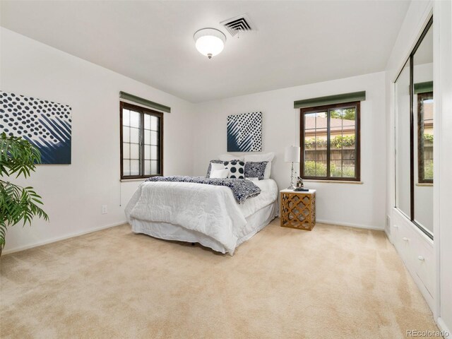 bedroom with light colored carpet