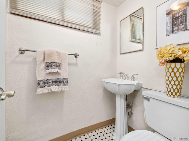 bathroom with tile patterned flooring and toilet