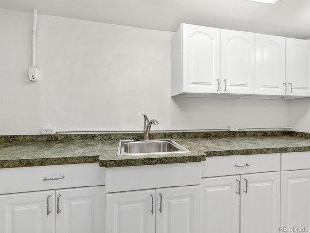 kitchen featuring white cabinets and sink