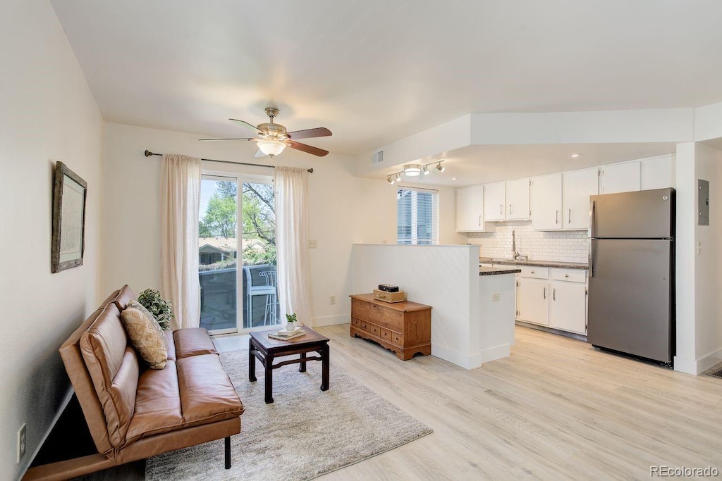 12486 W Nevada Pl Unit 106, Lakewood, CO 80228 - living area featuring baseboards, visible vents, light wood-style flooring, and a ceiling fan