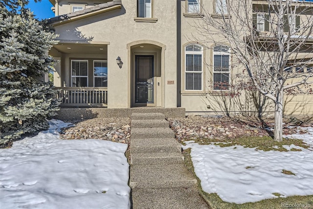 view of snow covered property entrance