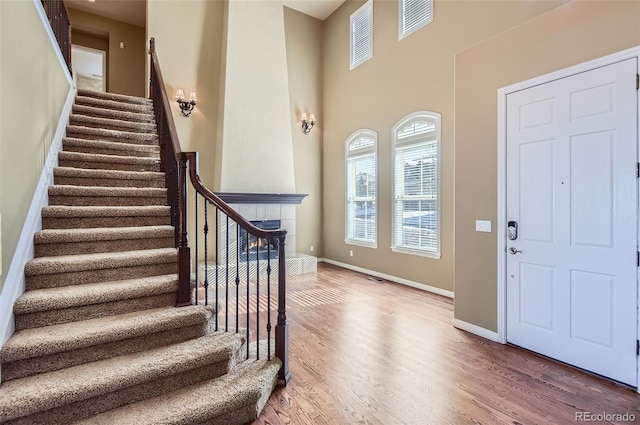 foyer featuring hardwood / wood-style flooring and a tiled fireplace