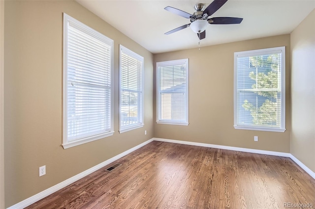 spare room featuring hardwood / wood-style flooring and ceiling fan