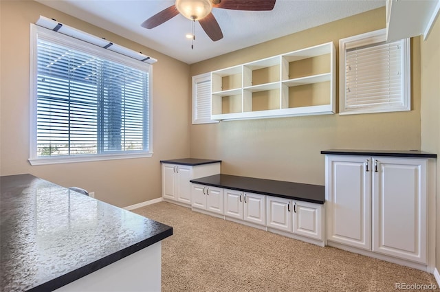 home office with light carpet and ceiling fan