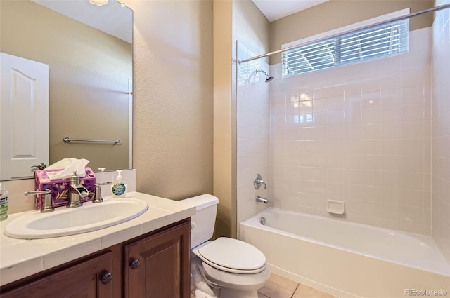 full bathroom with tile patterned floors, vanity, toilet, and tiled shower / bath